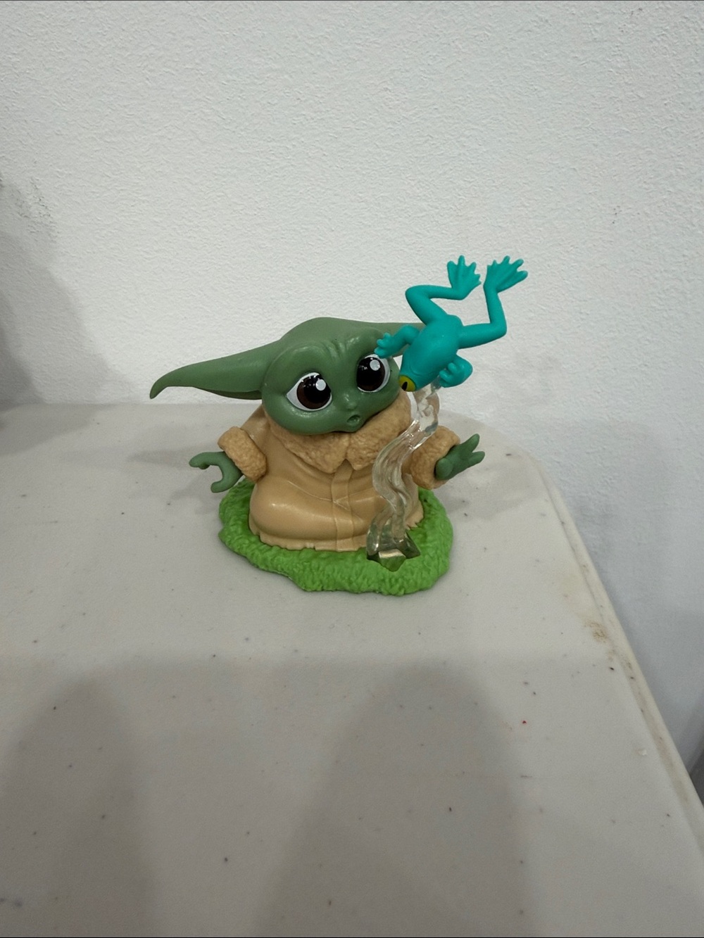 Grogu figure with frog
